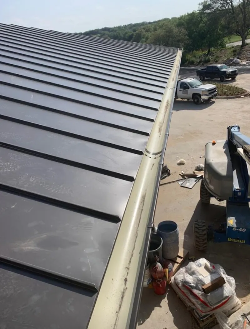 Standing seam panel and gutter detail on a metal roofing jobsite in Kearney